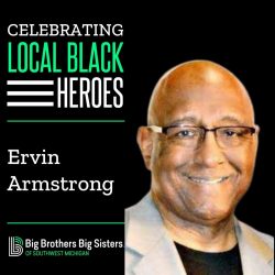 The Celebrating Local Black Heroes logo on top of the name Ervin Armstrong, on top of the BBBS logo. On the right is a picture of Armstrong, wearing a khaki coloured blazer, smiling at the camera.