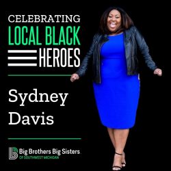On the left: "Celebrating Local Black Heroes" on top of the name "Sydney Davis," which is on top of the BBBS logo. On the right, Sydney is standing, smiling at the camera, wearing a blue dress and black jacket.