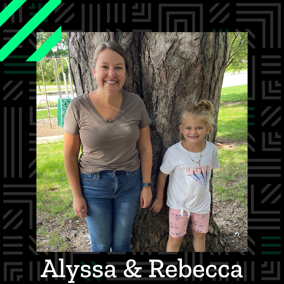 Alyssa and Rebecca stand in front of a tree next to one another, smiling. Across the bottom are their names.