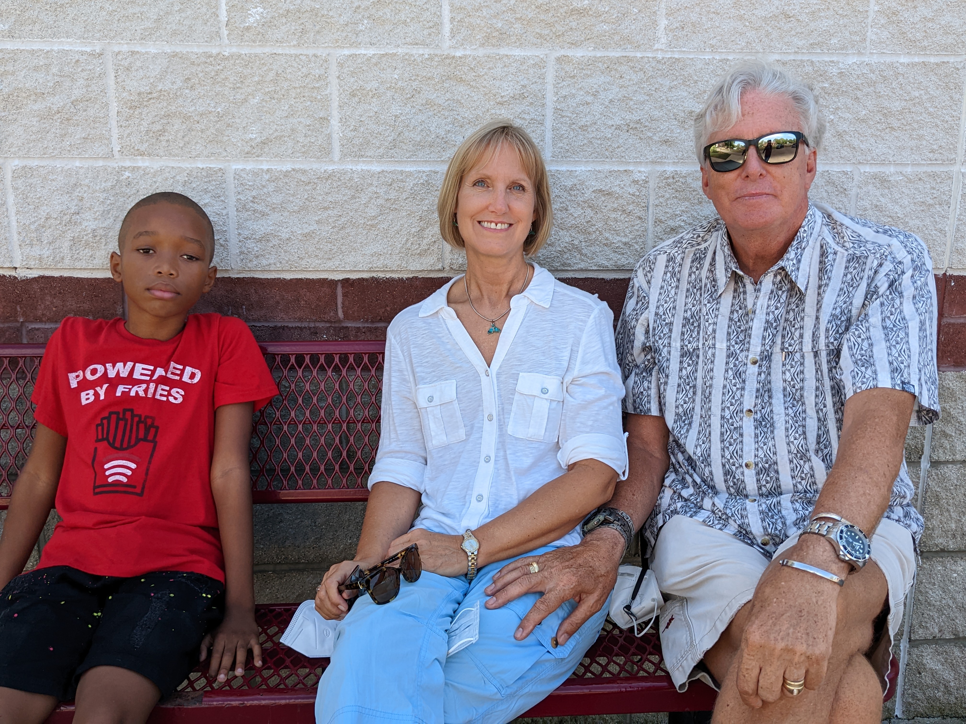 From the left, Jeremiah, Mary Roobol, and Paul Roobol, all sitting outside on a bench,