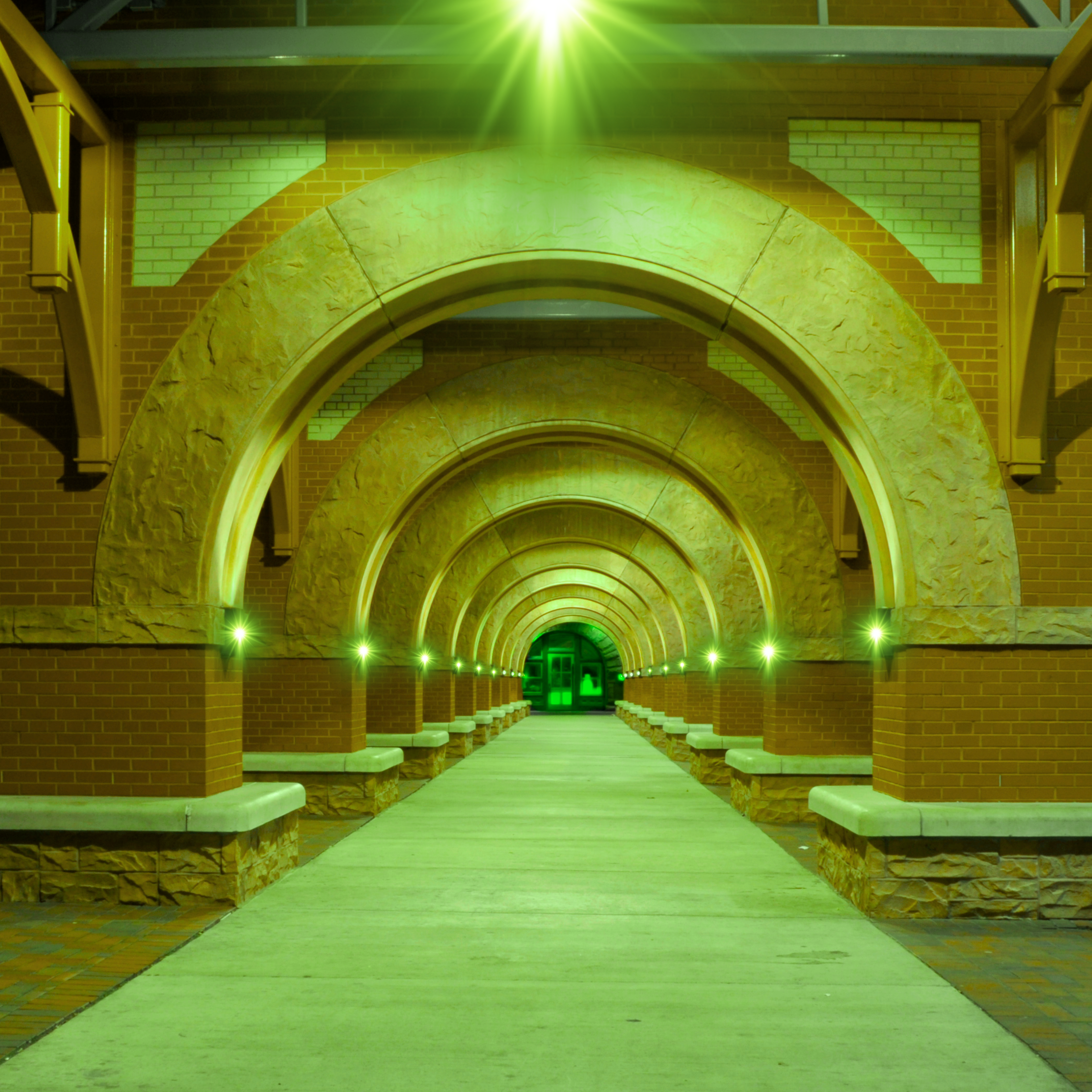A tunnel in downtown Kalamazoo that has all the lights changed out to green inside
