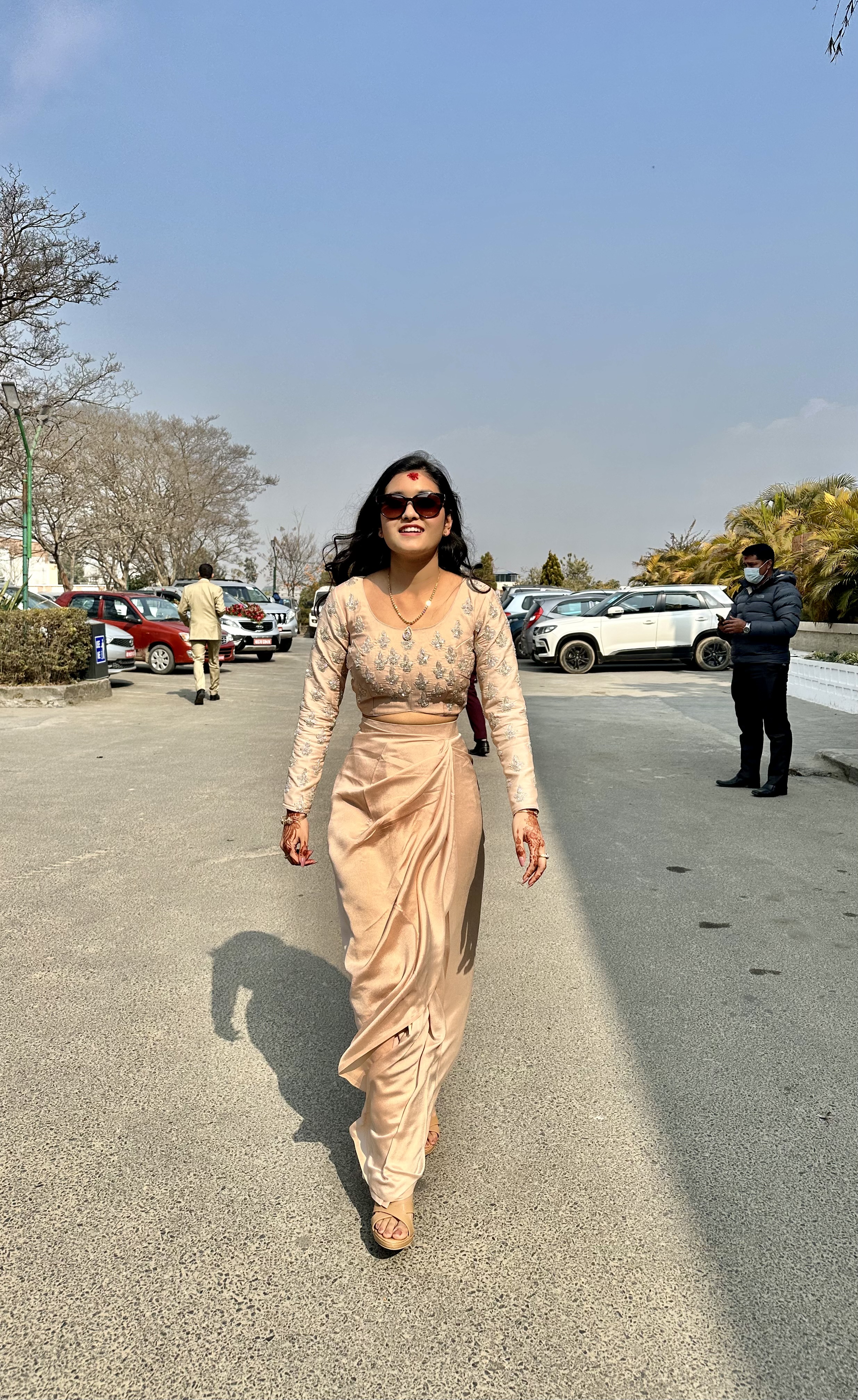 Asmina wearing a formal gown and sunglasses.